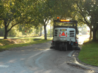 Street sweeper on right side of road