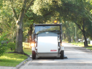 Street sweeper on left side of road